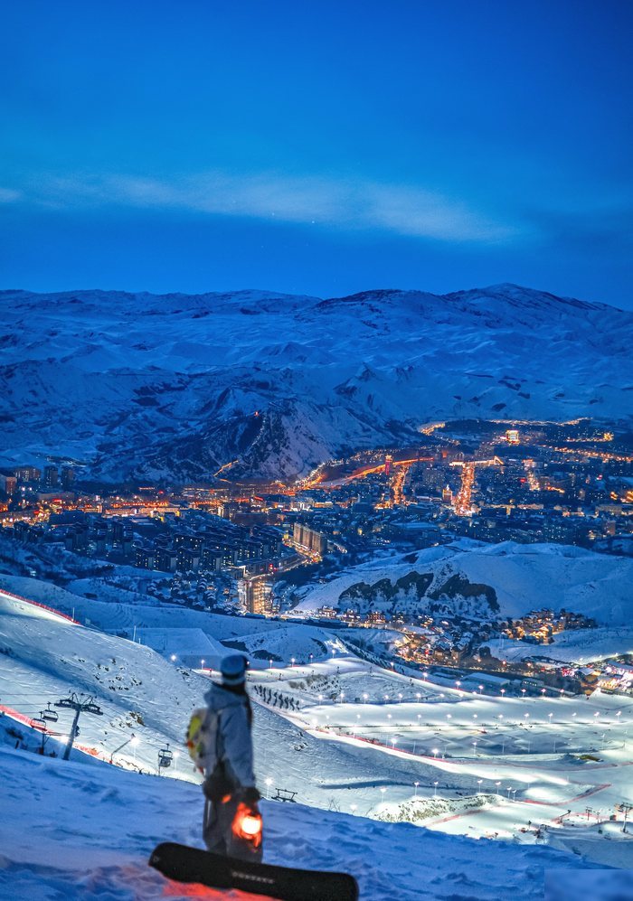 Night skiing above the lit city