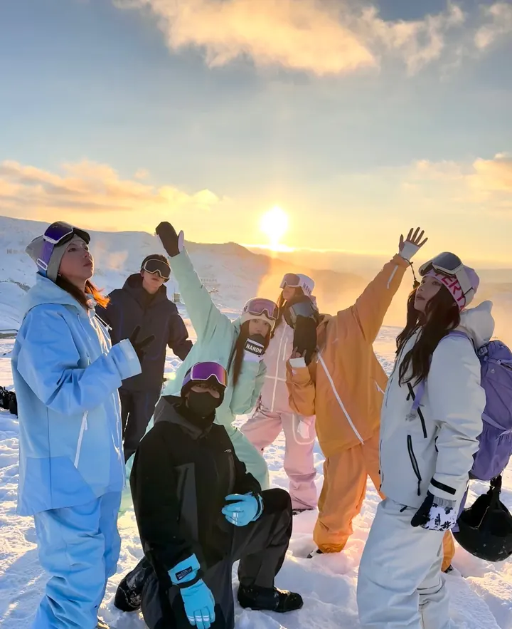 Small group in ski gear at sunset